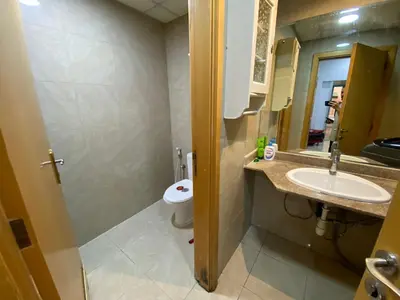 a bathroom with a sink and a toilet at Small Budget Rooms for 'girls' only in Dubai, Marina in Dubai