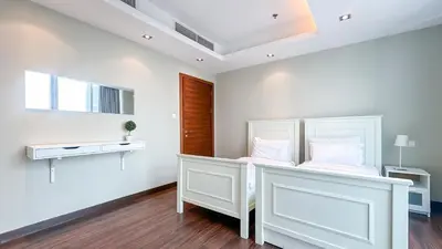 a bedroom with a white bed with white pillows at Luton Vacation Homes - The Marina Torch - Sea view - 64AB07 in Dubai