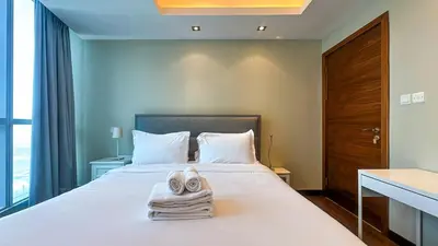 a bedroom with a bed with towels on it at Luton Vacation Homes - The Marina Torch - Sea view - 64AB07 in Dubai