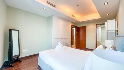 a bedroom with a white bed and a sink at Luton Vacation Homes - The Marina Torch - Sea view - 64AB07 in Dubai