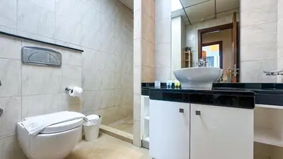a bathroom with a white toilet and a sink at Luton Vacation Homes - The Marina Torch - Sea view - 64AB07 in Dubai
