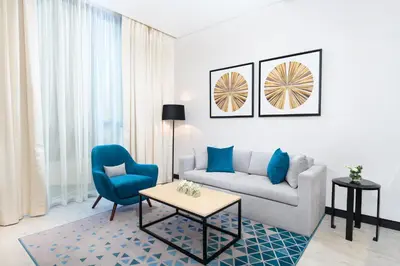 a living room with a couch and a table at Millennium Al Barsha in Dubai