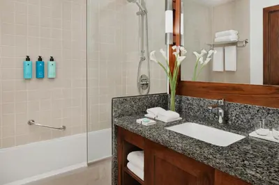 a bathroom with a sink and a shower at JA Ocean View Hotel, Jumeirah Beach Dubai in Dubai