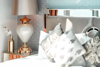 a bedroom with a bed with a lamp and pillows at Elite Royal Apartment - Full Bujr Khalifa & Fountain View - Senator - 2 bedrooms & 1 open bedroom without partition in Dubai