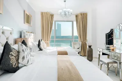 a bedroom with a large white bed with a window at Elite Royal Apartment - Full Bujr Khalifa & Fountain View - Senator - 2 bedrooms & 1 open bedroom without partition in Dubai