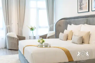 a bedroom with a large bed with a tray on it at Westminster Burj Residences in Dubai