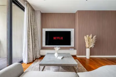 a living room with a tv on a wall at City walk apartment Specter in Dubai