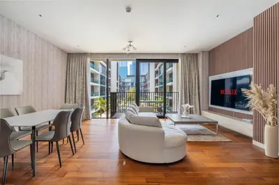 a living room with a couch and a table and a tv at City walk apartment Specter in Dubai