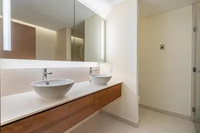 a bathroom with two sinks and a mirror at City walk apartment Specter in Dubai