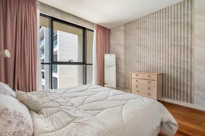 a bedroom with a white bed and a window at City walk apartment Specter in Dubai
