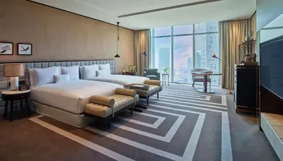 a hotel room with a large bed and a desk at Waldorf Astoria Dubai International Financial Centre in Dubai