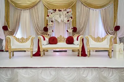 a room with two chairs and a throne with red flowers at Millennium Plaza Downtown Suites in Dubai
