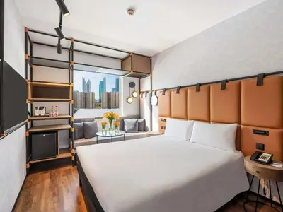 a hotel room with a large bed and a window at ibis Dubai World Trade Centre in Dubai