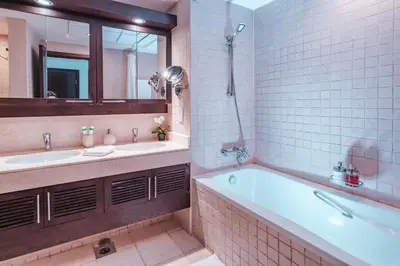 a bathroom with two sinks and a tub and a mirror at Elite Royal Apartment - Full Burj Khalifa & fountain view - Pearl in Dubai