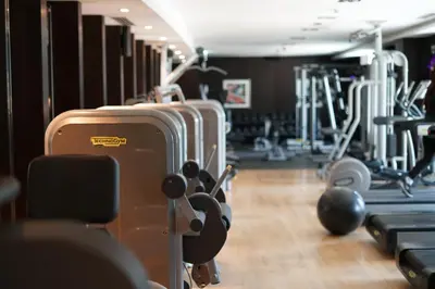 a gym with rows of tread machines and suitcases at Elite Royal Apartment - Full Burj Khalifa & fountain view - Pearl in Dubai