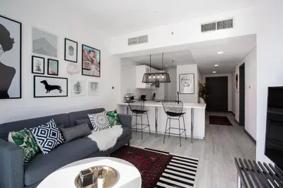 a living room with a couch and a kitchen at Wow! Super Luxury Apartment in Dubai Marina - 1BR RO in Dubai