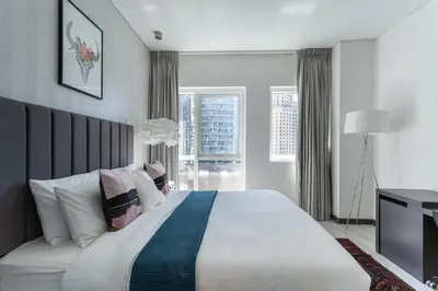 a bedroom with a large bed and a television at Wow! Super Luxury Apartment in Dubai Marina - 1BR RO in Dubai