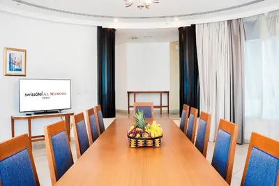 a dining room with a table with a bowl of fruit at Roda Al Murooj Residences in Dubai