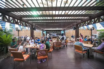 a group of people sitting at tables in a restaurant at Roda Al Murooj Residences in Dubai
