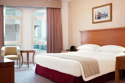 a hotel room with a bed and a desk and a chair at Roda Al Murooj Residences in Dubai