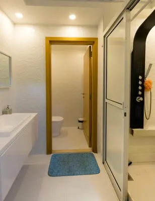 a bathroom with a sink and a toilet and a door at comfortable Rooms For Girls in Marina Dubai, the best offer in Dubai