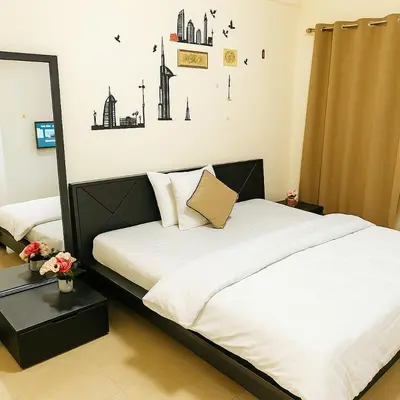 a bedroom with a bed with white sheets and a mirror at comfortable Rooms For Girls in Marina Dubai, the best offer in Dubai