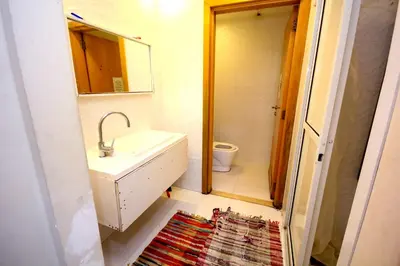 a bathroom with a sink and a toilet and a mirror at comfortable Rooms For Girls in Marina Dubai, the best offer in Dubai
