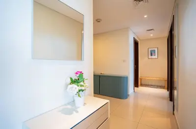 a hallway with a vase of flowers on a table at New Arabian -Panorama 2 BR Full Golf course View in Dubai