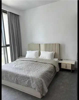 a bedroom with a large bed and a window at Downtown Al Bahar Apartments in Dubai