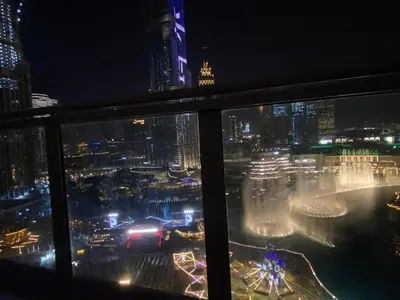 a view of a city at night from a window at Downtown Al Bahar Apartments in Dubai