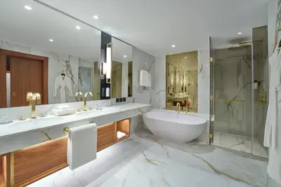 a bathroom with two sinks and a tub and a shower at Grand Hyatt Dubai Resort & Waterpark in Dubai