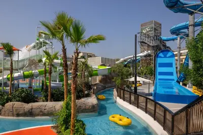 a pool at a resort with a water slide at Grand Hyatt Dubai Resort & Waterpark in Dubai