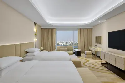 a hotel room with two beds and a flat screen tv at Grand Hyatt Dubai Resort & Waterpark in Dubai