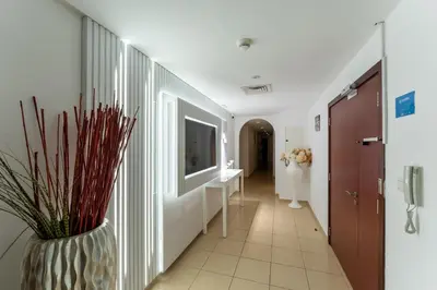 a hallway with a vase with a plant in it at Jbr penthouse with terrace pool in Dubai
