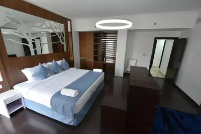 a bedroom with a large bed and a mirror at Jbr penthouse with terrace pool in Dubai