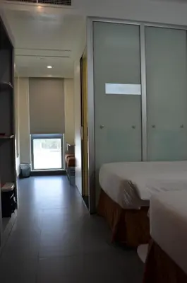 a hotel room with a bed and a sliding glass door at JOIN INN HOTEL Jebel Ali, Dubai - Formerly easyHotel Jebel Ali in Dubai