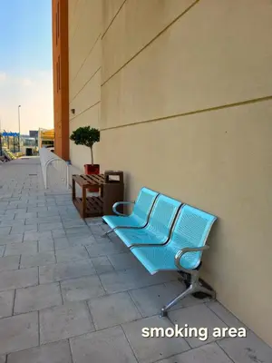 a blue bench sitting on the side of a building at JOIN INN HOTEL Jebel Ali, Dubai - Formerly easyHotel Jebel Ali in Dubai