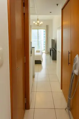a room with a hallway with a living room at Deluxe Studio for Rent at Marina View Towers in Dubai