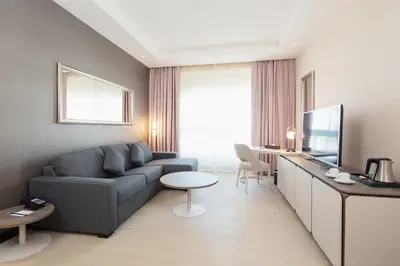 a living room with a couch and a table at Barcelo Al Jaddaf, Dubai in Dubai
