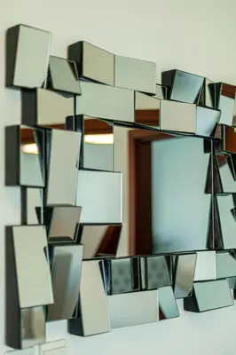 a mirror hanging on a wall with many mirrors at AUBERGE Luxury 2BR Full Burj Khalifa and Fountain View in Dubai