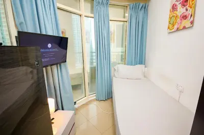 a small room with a bed and a tv in it at Nice Single Rooms for 