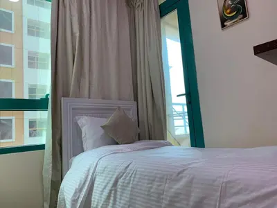 a bedroom with a white bed with a window at Nice Single Rooms for 