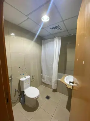 a bathroom with a toilet and a sink and a light at Nice Single Rooms for 