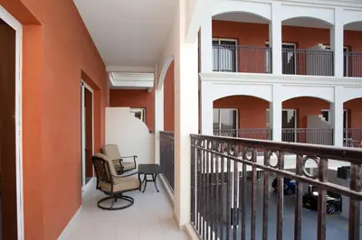 a balcony with orange walls and a chair at BLVD - Spacious Fully Equipped Luxury Residences - Dubai - JVC in Dubai