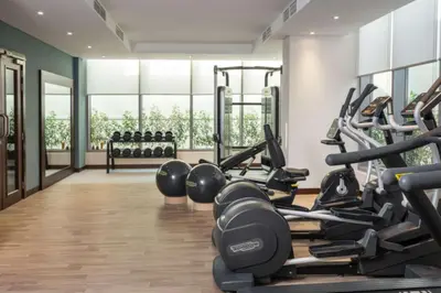 a gym with treadmills and weights in a room at Hampton By Hilton Dubai Al Barsha in Dubai