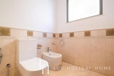 a bathroom with a toilet and a sink at LUX - The Ocean Pearl Villa in Dubai