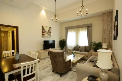 a living room with a couch and a table at Marbella Holiday Homes in Dubai