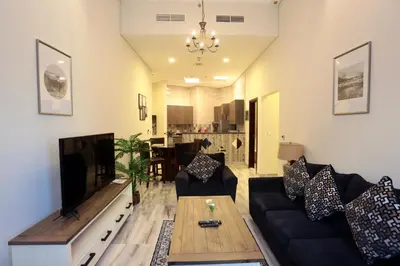 a living room with a couch and a coffee table at Marbella Holiday Homes in Dubai