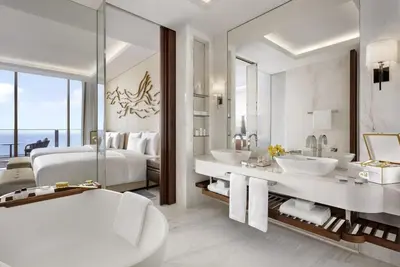 a bathroom with two sinks and a large mirror at Atlantis The Royal in Dubai
