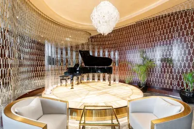 a living room with a piano and chairs at Paramount Hotel Dubai in Dubai